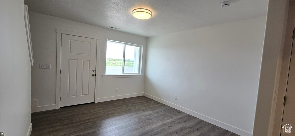 Entryway with dark wood-style flooring and baseboards