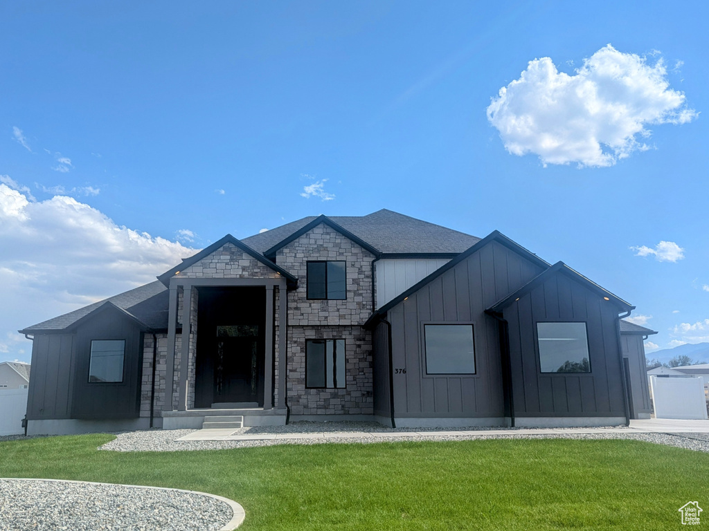 View of front of home featuring board and batten siding and stone siding