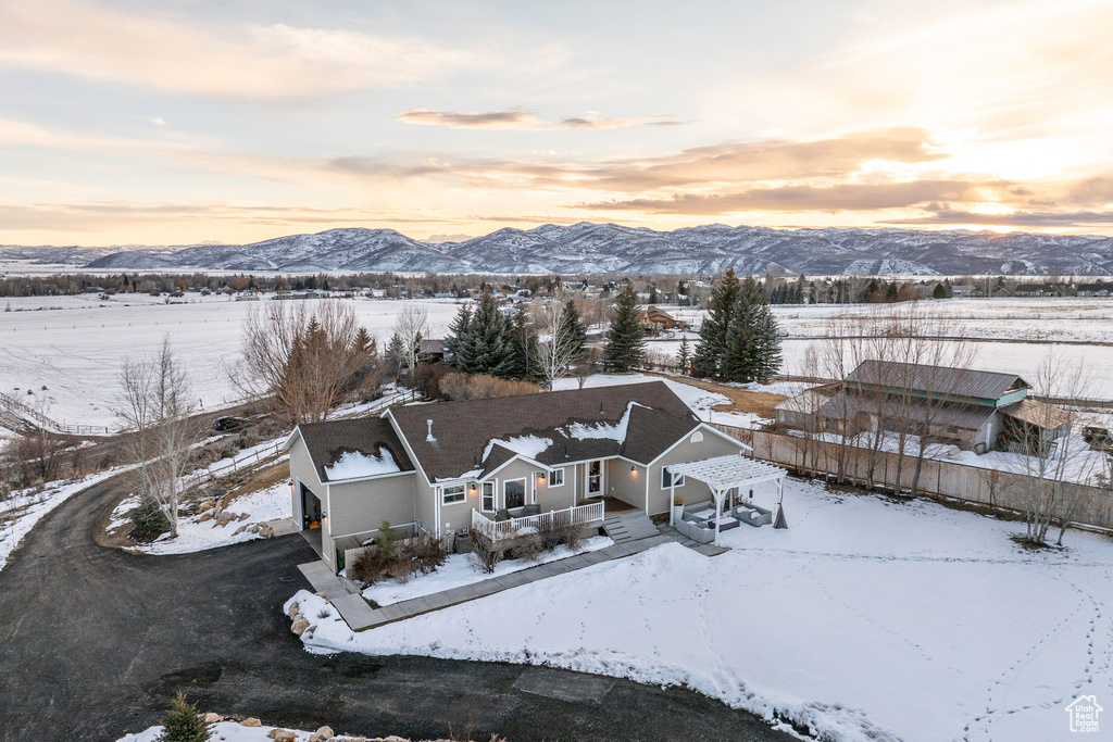 Snowy aerial view featuring a mountain view