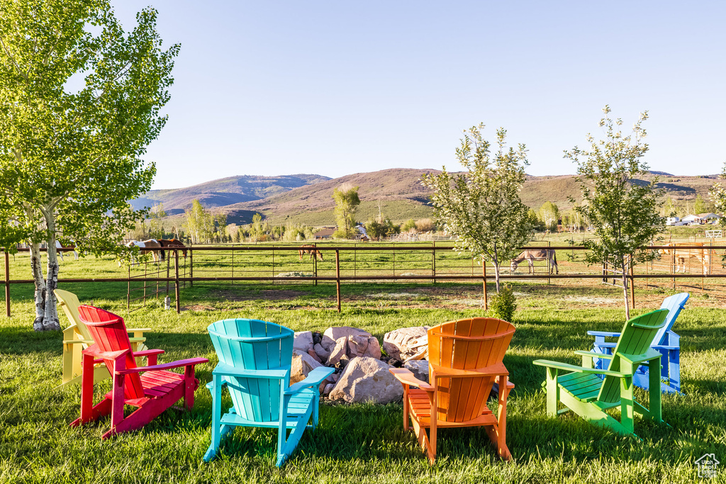 View of yard with a fire pit, a mountain view, and a rural view