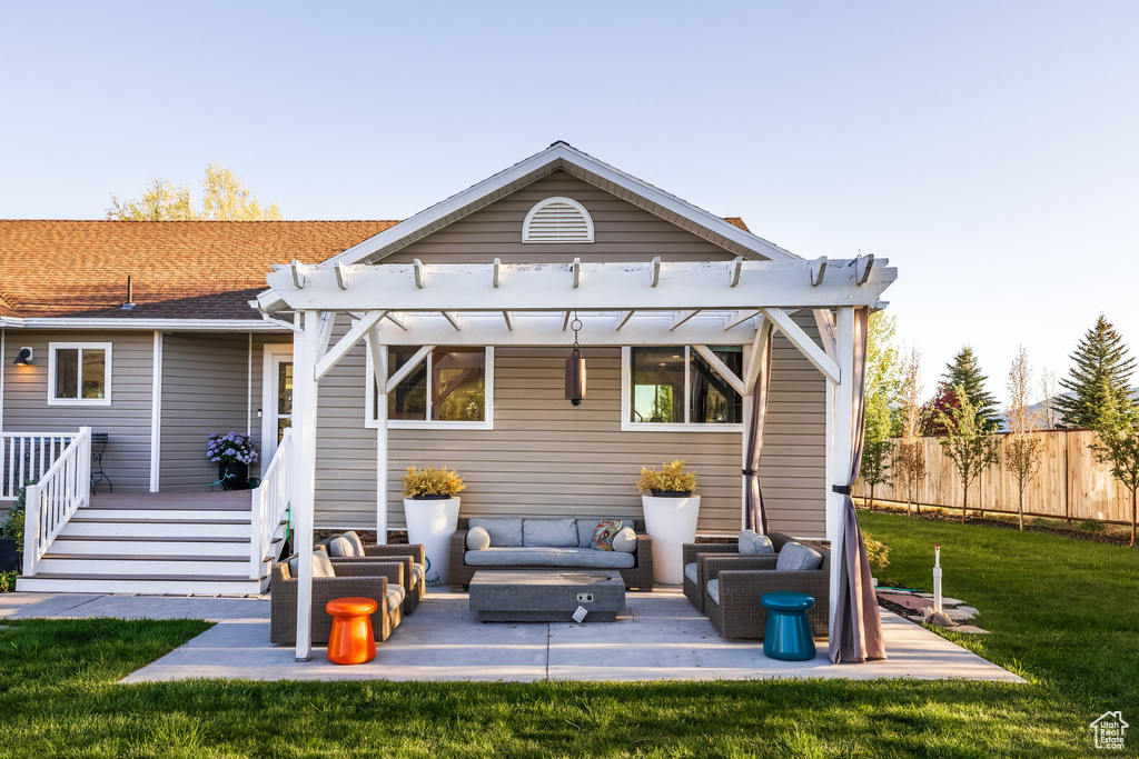 Back of house featuring outdoor lounge area, a pergola, a patio area, and a wooden deck