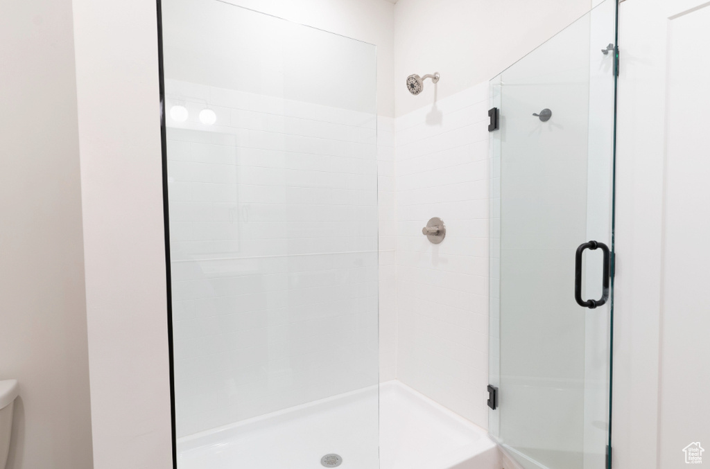Bathroom with toilet and a stall shower