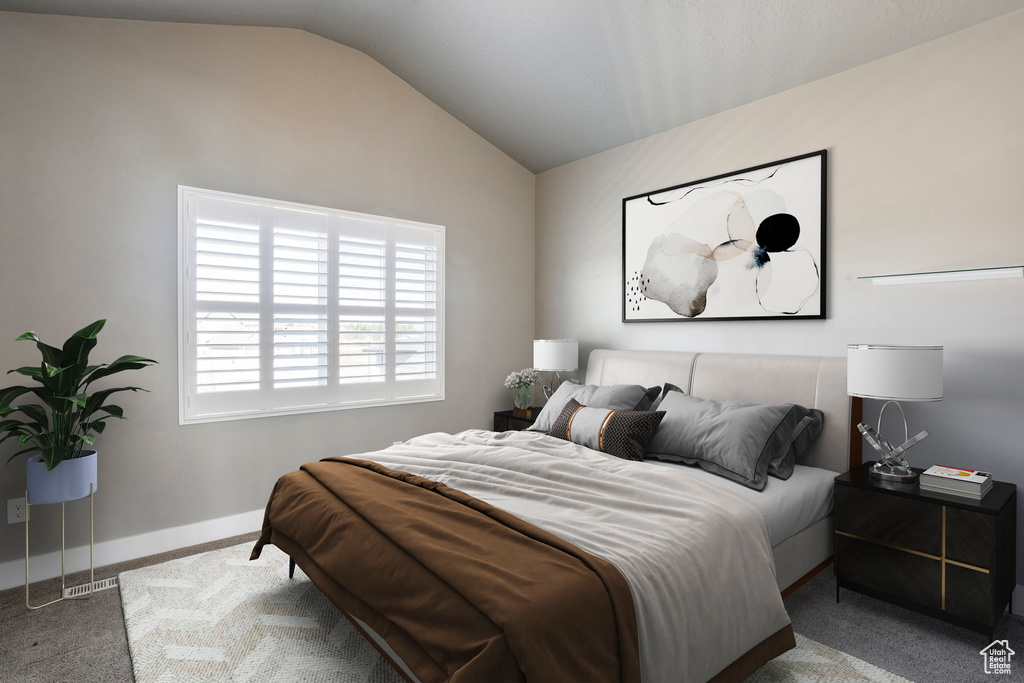Carpeted bedroom with lofted ceiling and baseboards
