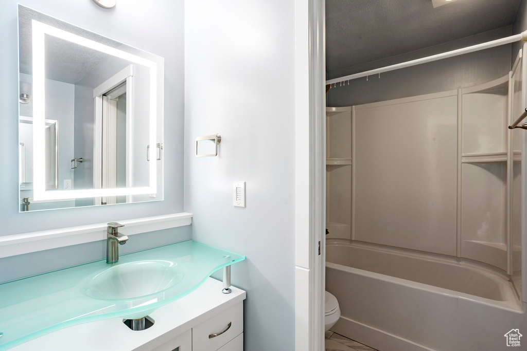 Full bath featuring toilet, shower / bath combination, and vanity