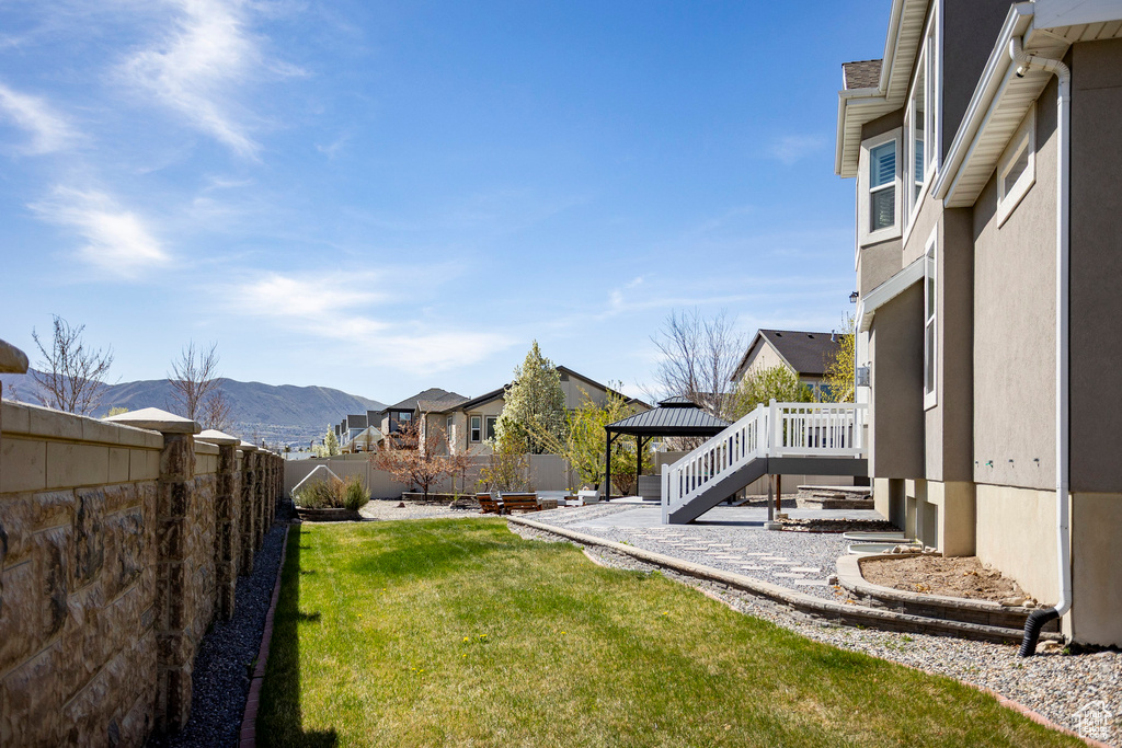 View of yard with a residential view, a mountain view, a patio area, a fenced backyard, and a gazebo