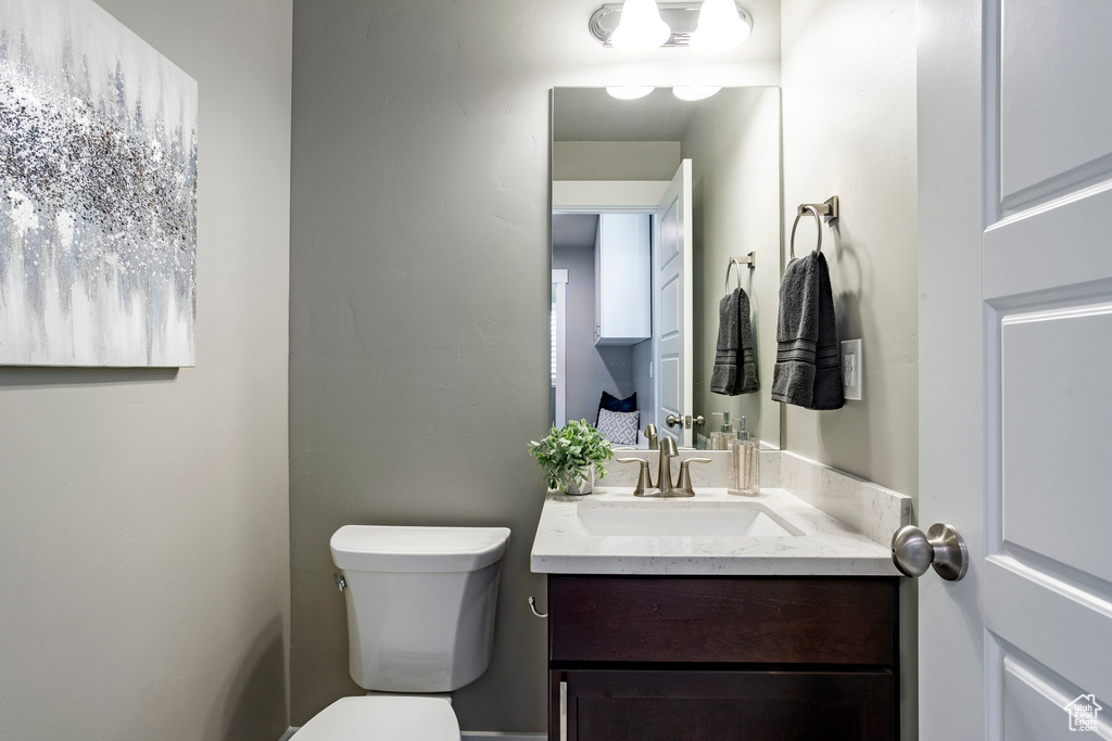 Half bathroom featuring toilet and vanity