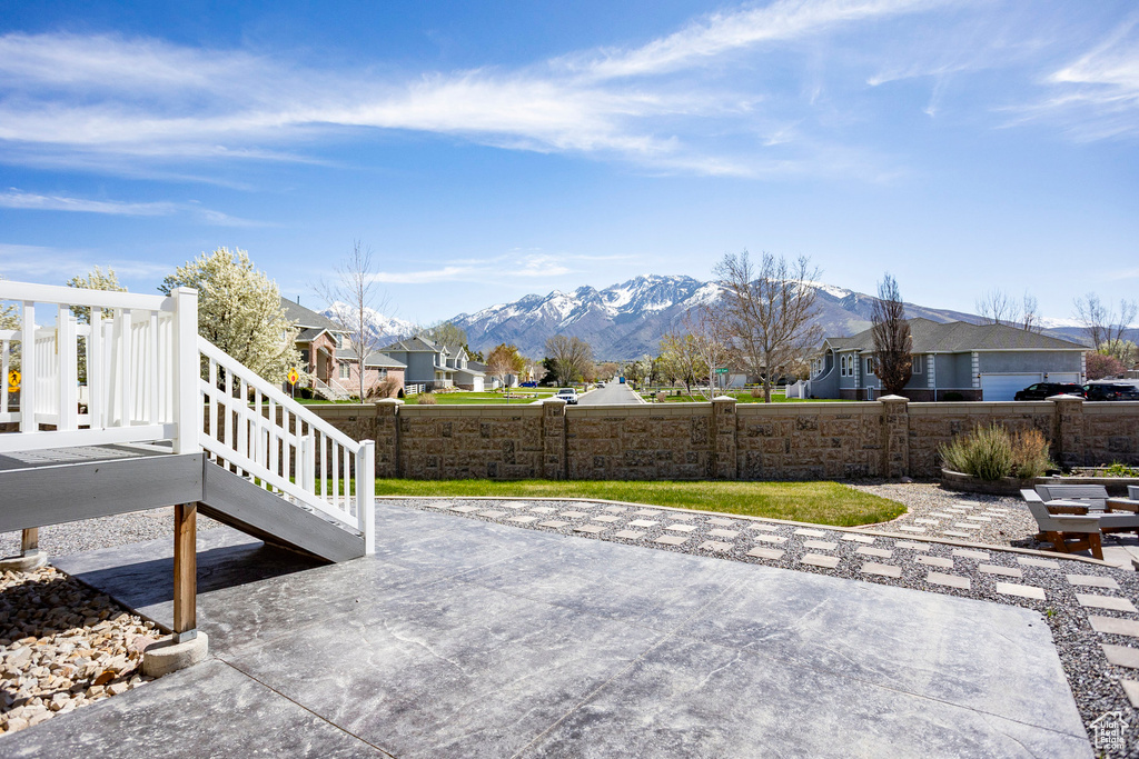 View of patio / terrace with a residential view, fence, and a mountain view