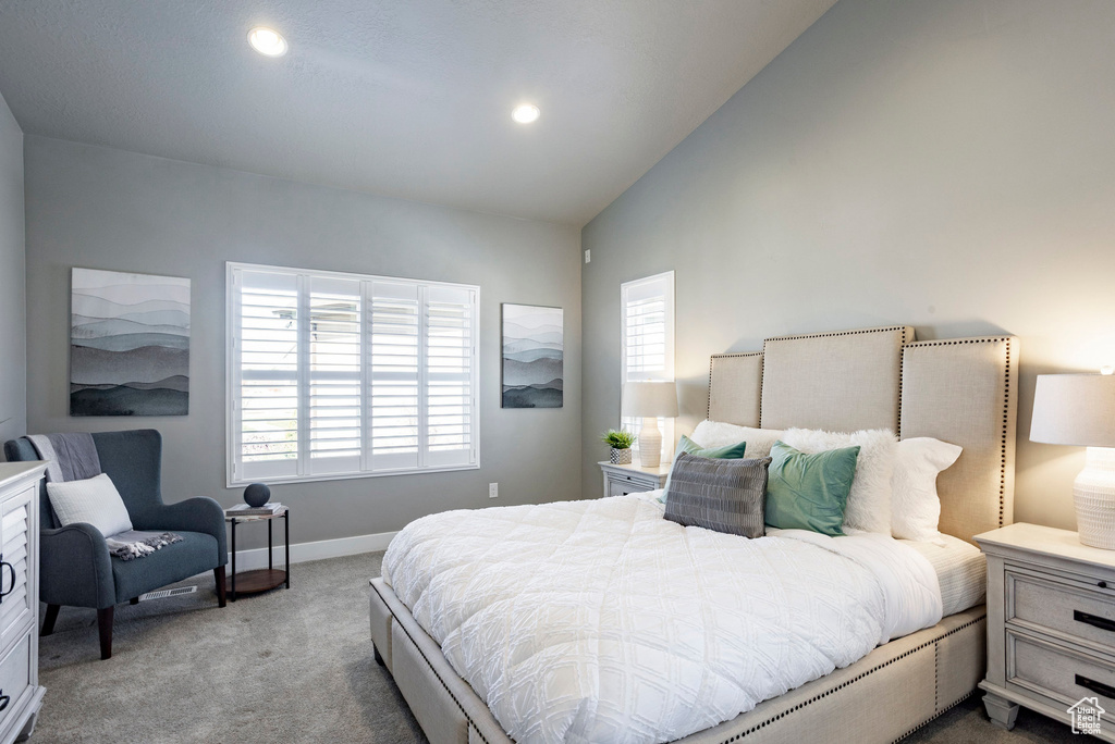 Carpeted bedroom with recessed lighting, baseboards, multiple windows, and vaulted ceiling