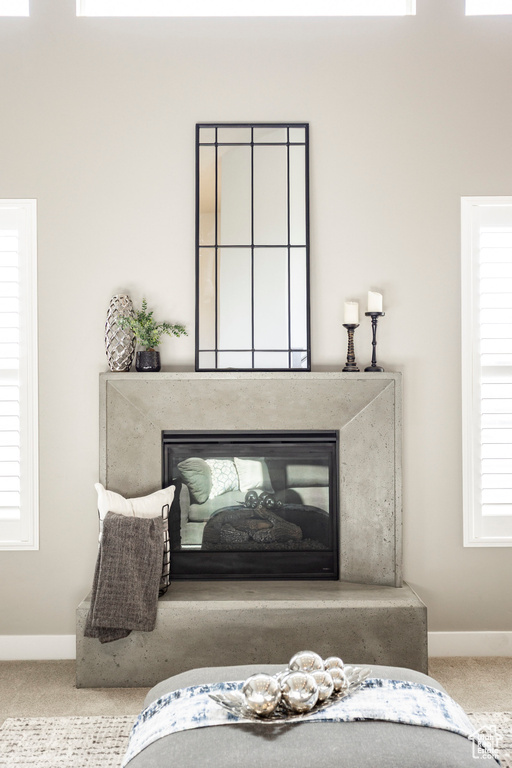 Details featuring baseboards, a high end fireplace, and carpet