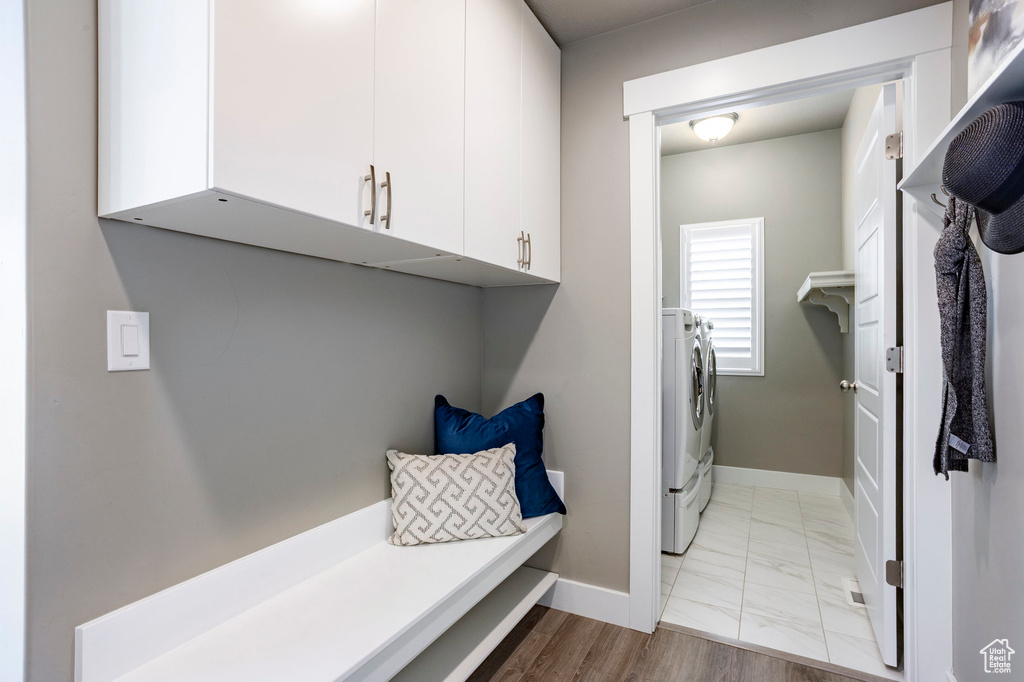 Mudroom featuring baseboards, washing machine and dryer, and marble finish floor