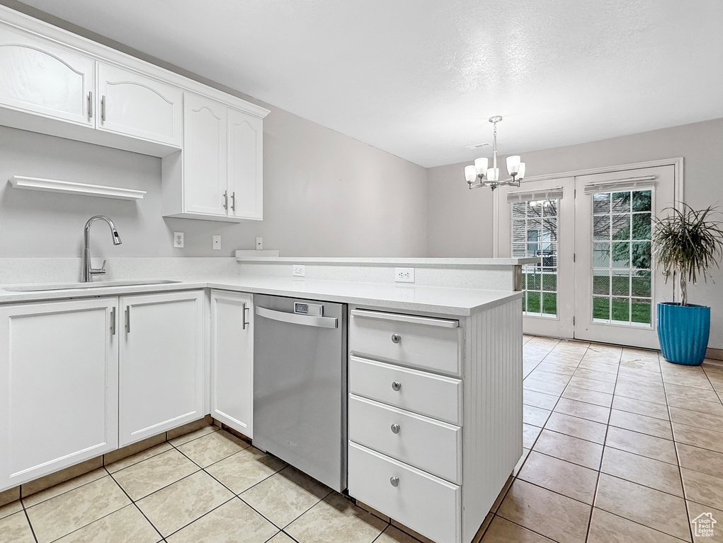 Kitchen featuring a sink, light countertops, a chandelier, a peninsula, and stainless steel dishwasher