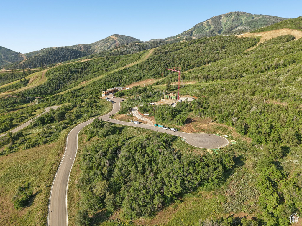 Aerial overview of property's location featuring a mountainous background