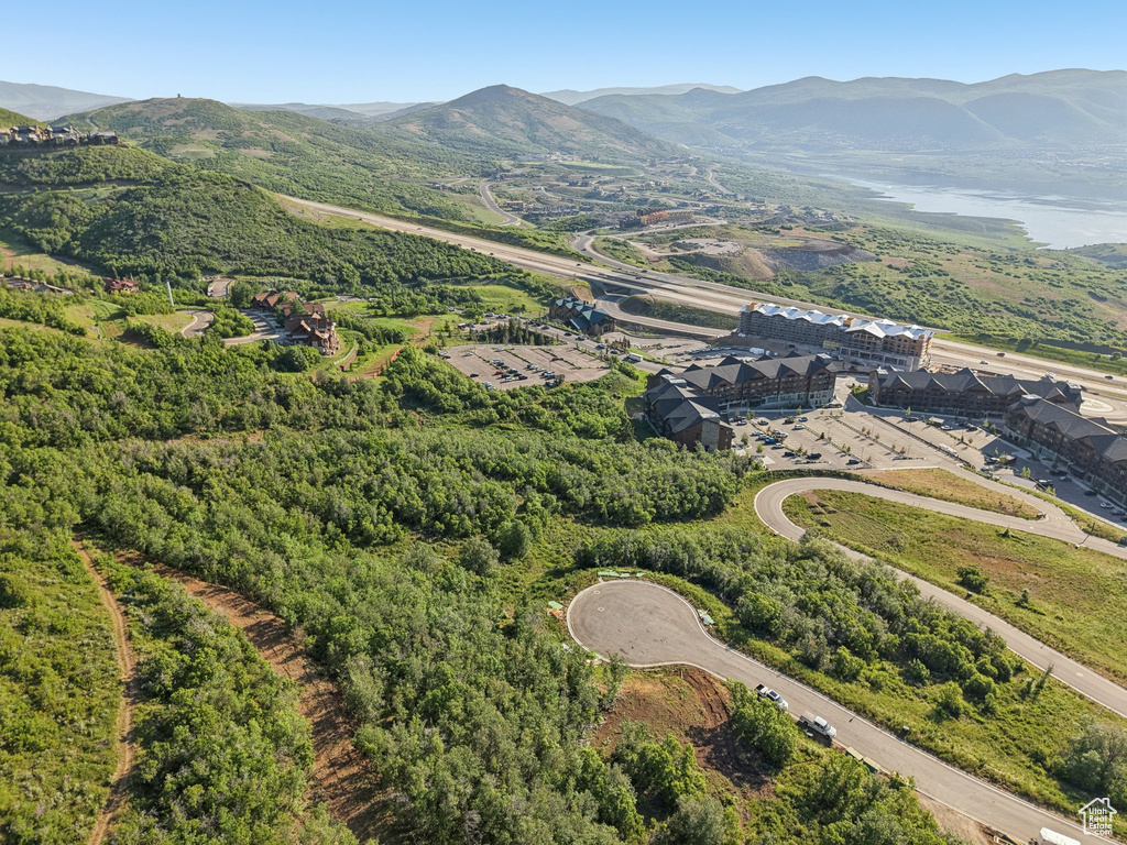 Aerial view of property and surrounding area featuring mountains