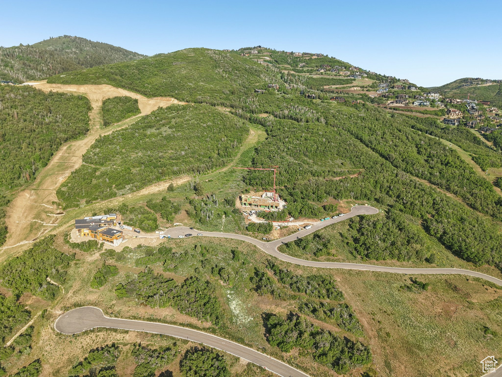 Aerial view of property's location with a mountainous background