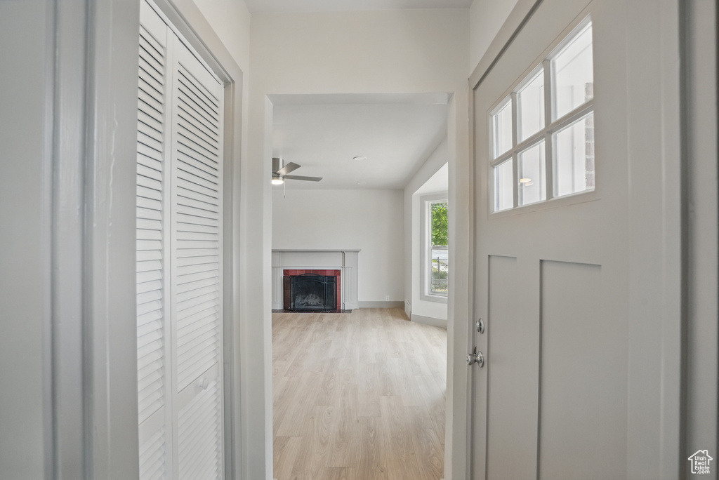 Hall featuring light wood-style flooring and baseboards