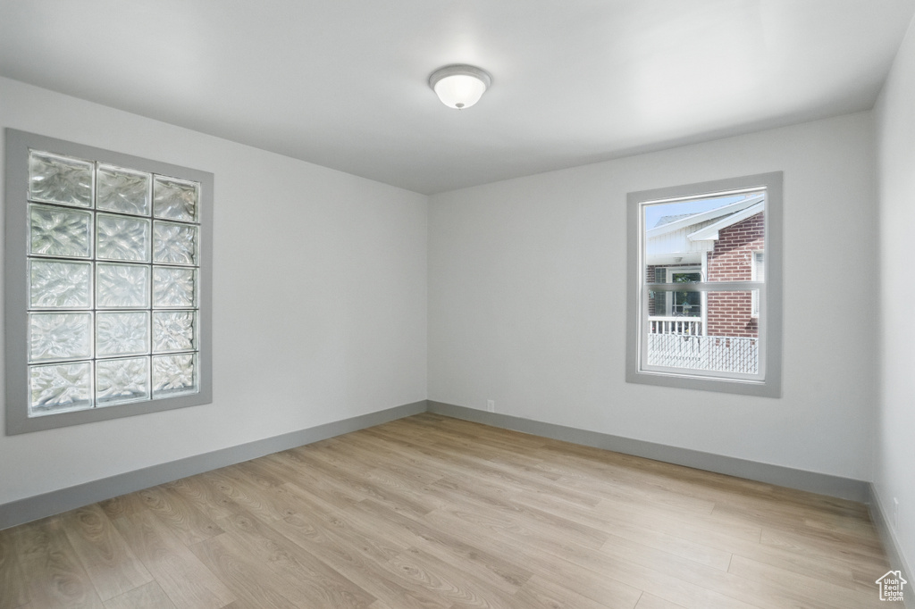Empty room featuring light wood-type flooring and baseboards