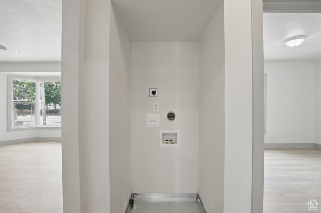 Washroom featuring electric dryer hookup, washer hookup, and baseboards