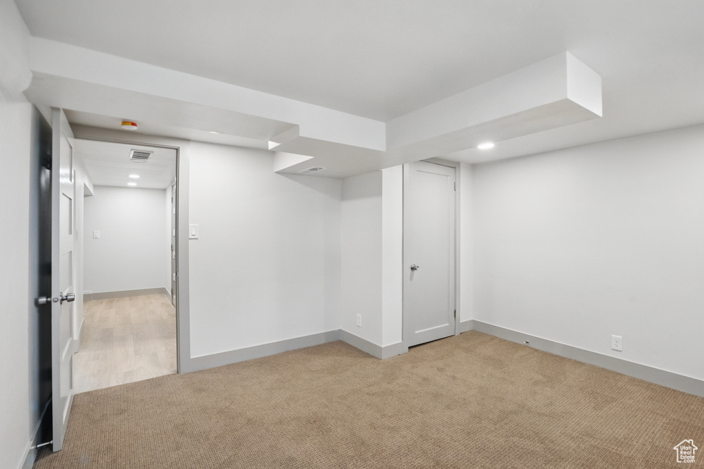 Finished below grade area with light carpet, recessed lighting, and baseboards