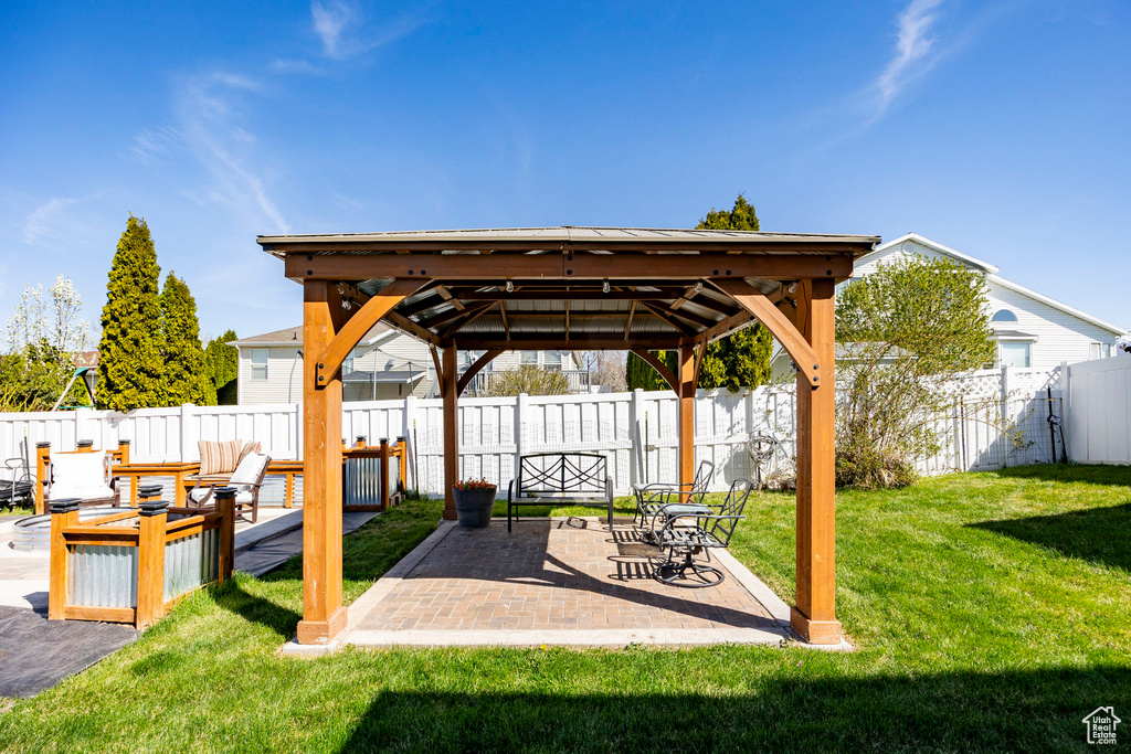 Fenced backyard with a gazebo and a patio