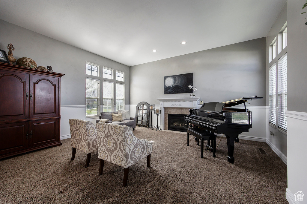 Carpeted living room with a tiled fireplace, healthy amount of natural light, and recessed lighting
