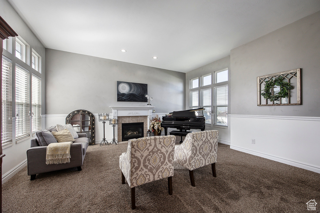 Carpeted living room with a tile fireplace and recessed lighting