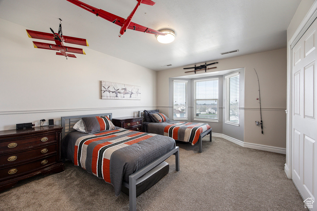 Bedroom with carpet floors and baseboards