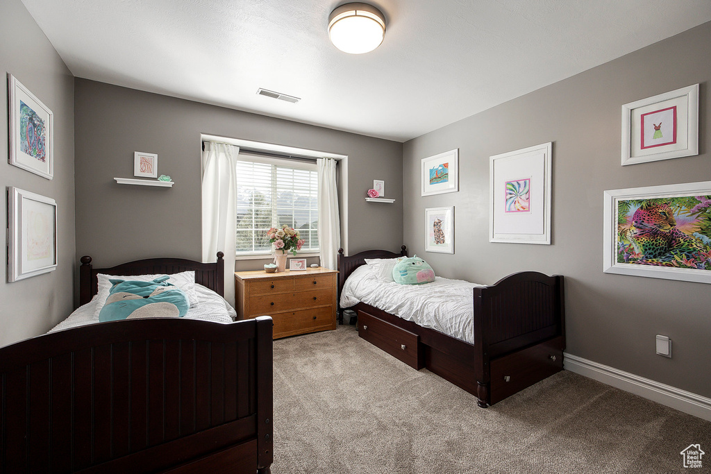 Carpeted bedroom with baseboards