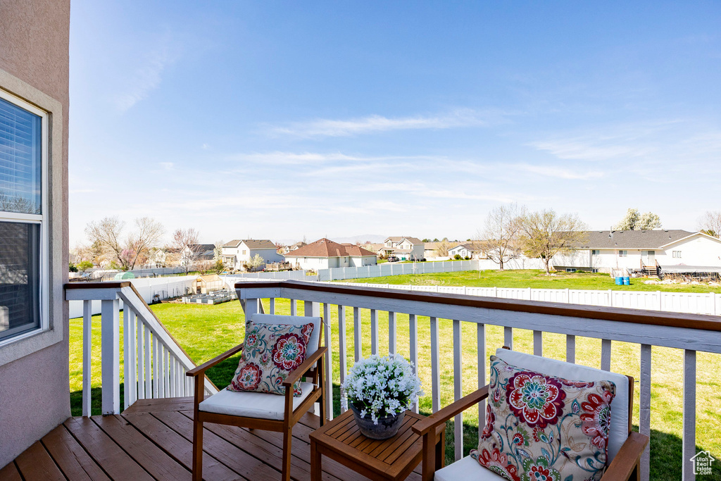 Deck with a residential view and a fenced backyard