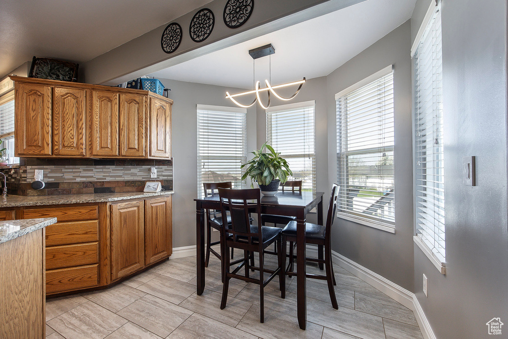 Dining area with a chandelier and baseboards