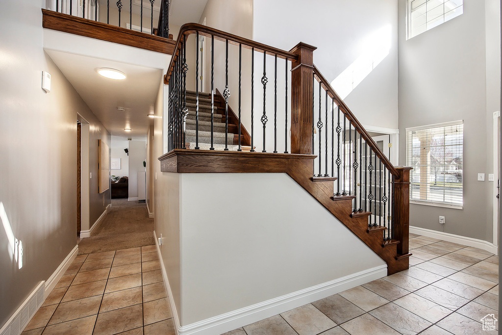 Staircase with a towering ceiling