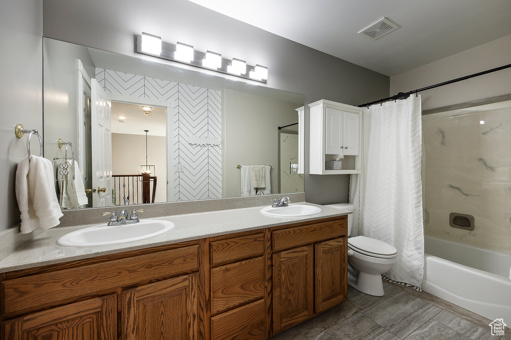 Full bath featuring double vanity and shower / tub combo