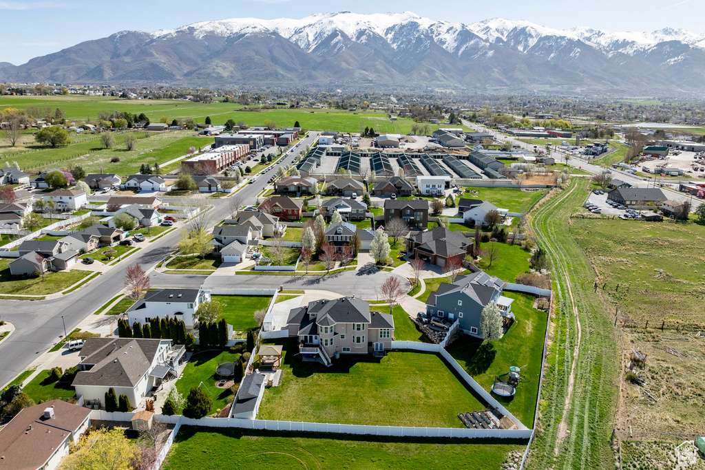 Aerial view of property's location featuring a mountainous background and nearby suburban area
