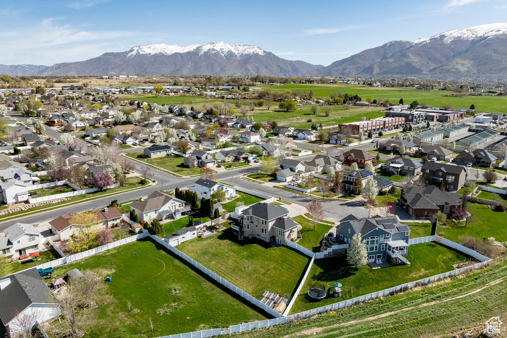 Aerial overview of property's location with a mountainous background and nearby suburban area