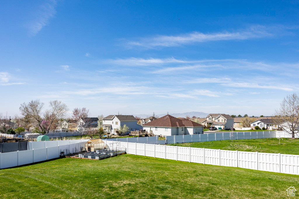Fenced backyard with a residential view