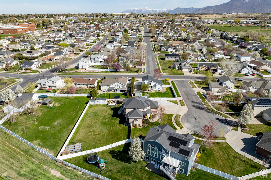 Aerial view of property's location with nearby suburban area and a mountain backdrop