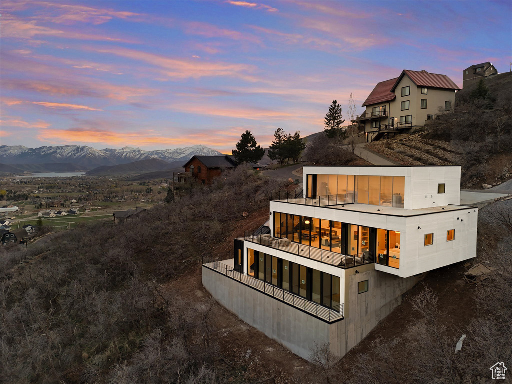 Rear view of house with a balcony and a mountain view