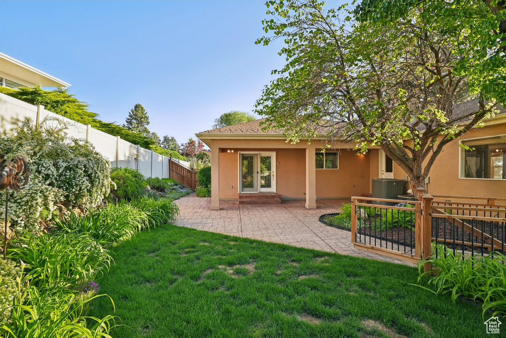 Back of property featuring stucco siding, a patio, and central AC unit
