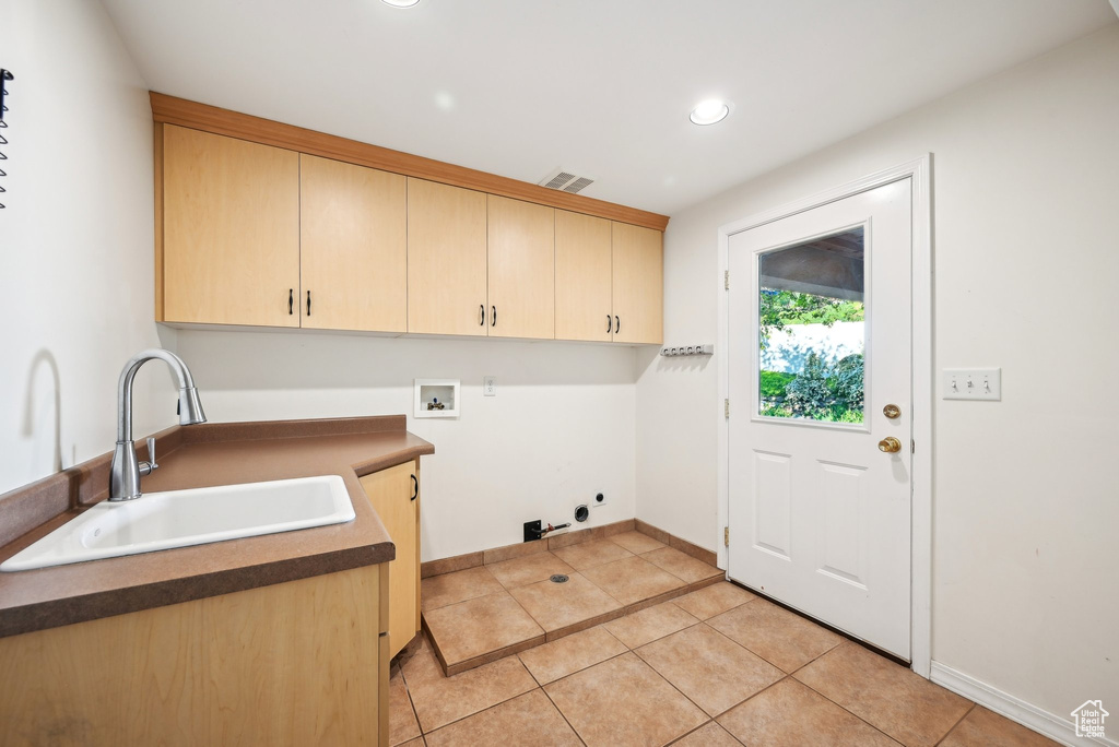Laundry room featuring cabinet space, hookup for a washing machine, light tile patterned flooring, recessed lighting, and baseboards
