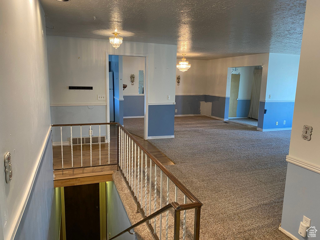 Interior space featuring a textured ceiling and baseboards