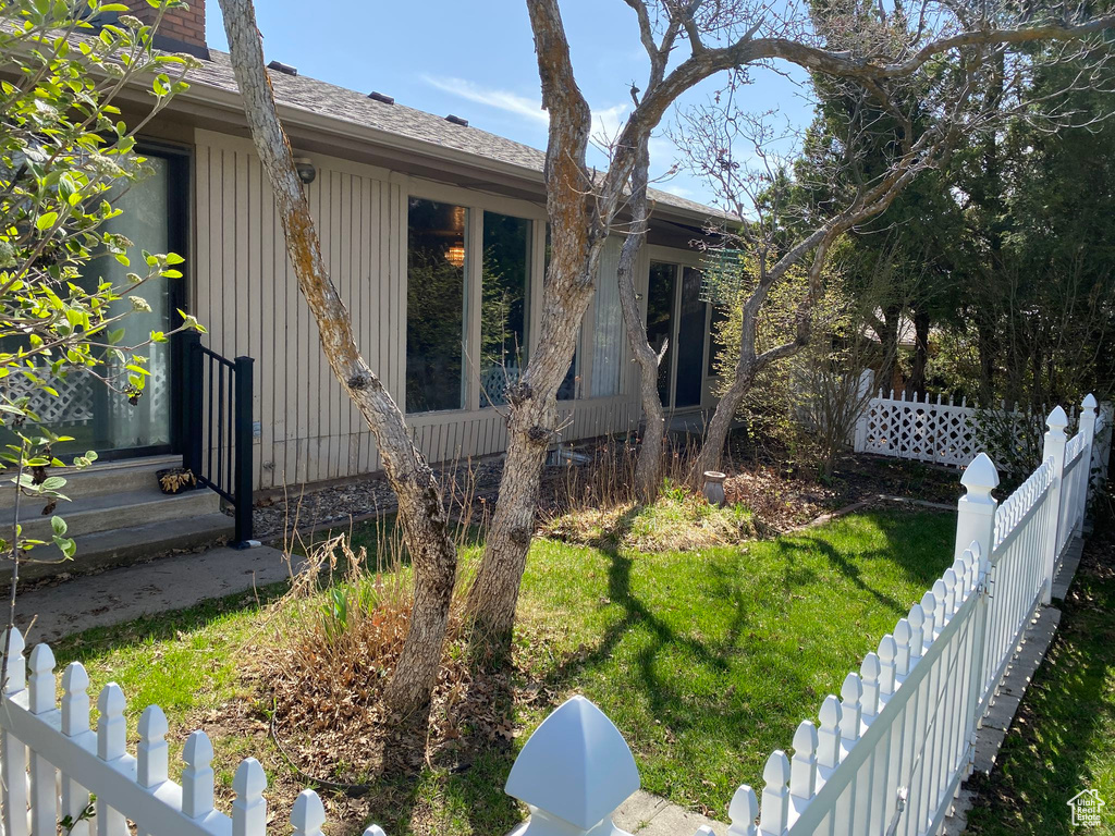 View of home's exterior featuring a fenced backyard and a lawn