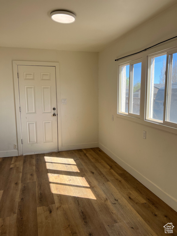 Unfurnished room featuring baseboards and wood finished floors