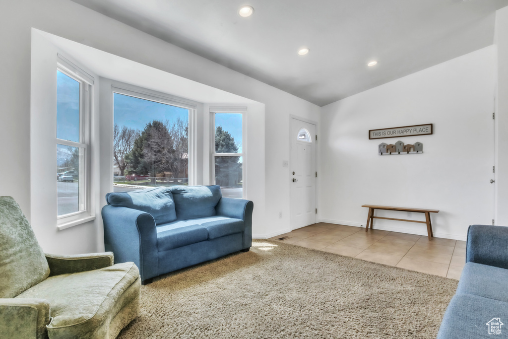 Tiled living room with recessed lighting, baseboards, and a healthy amount of sunlight