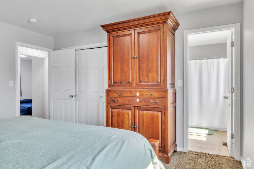 Tiled bedroom featuring a closet