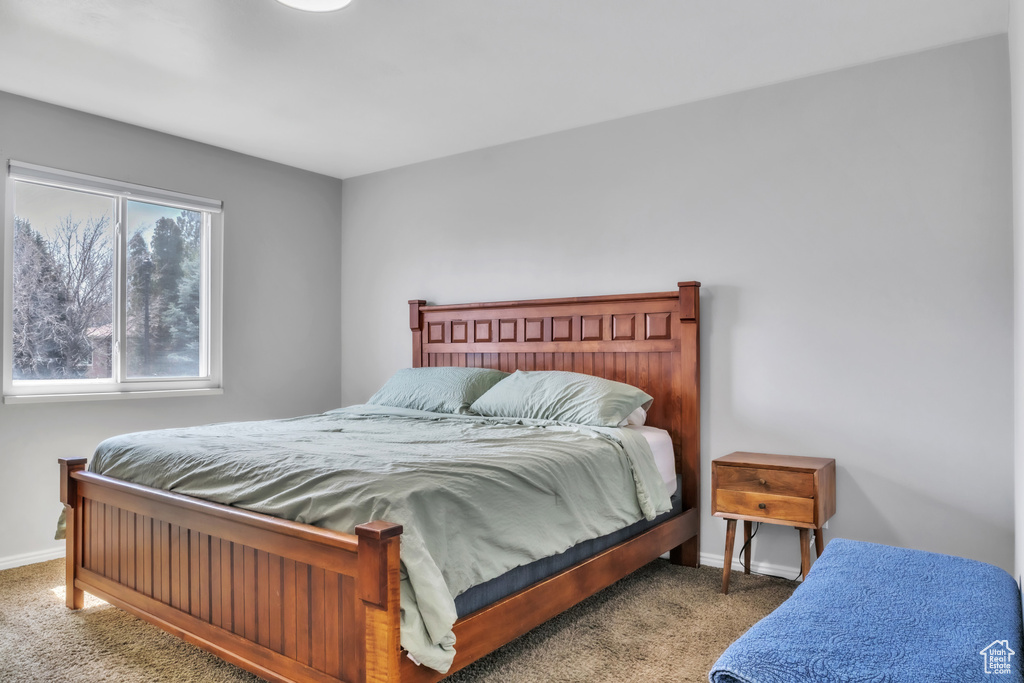 Carpeted bedroom featuring baseboards
