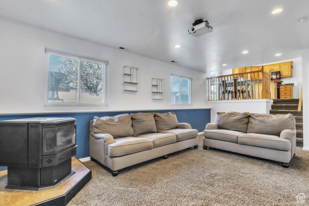 Carpeted living room with recessed lighting, plenty of natural light, and visible vents