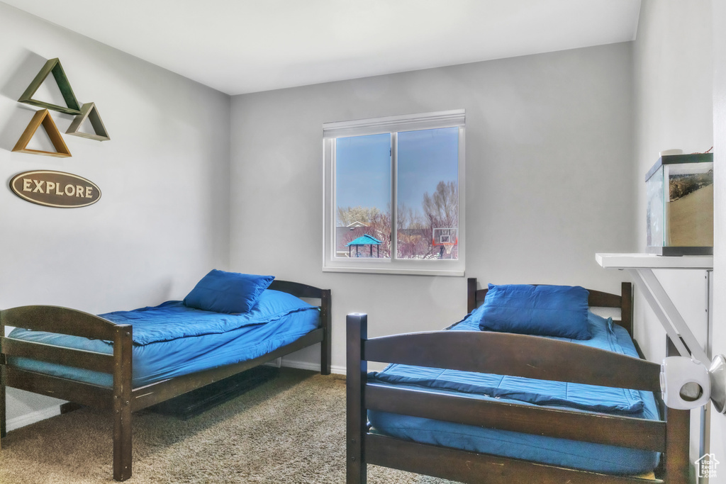 Bedroom featuring baseboards and carpet floors