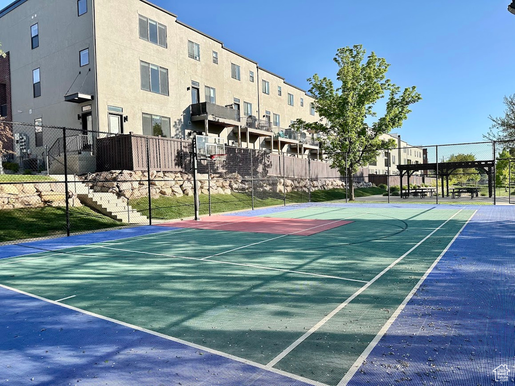 View of basketball court featuring fence and community basketball court