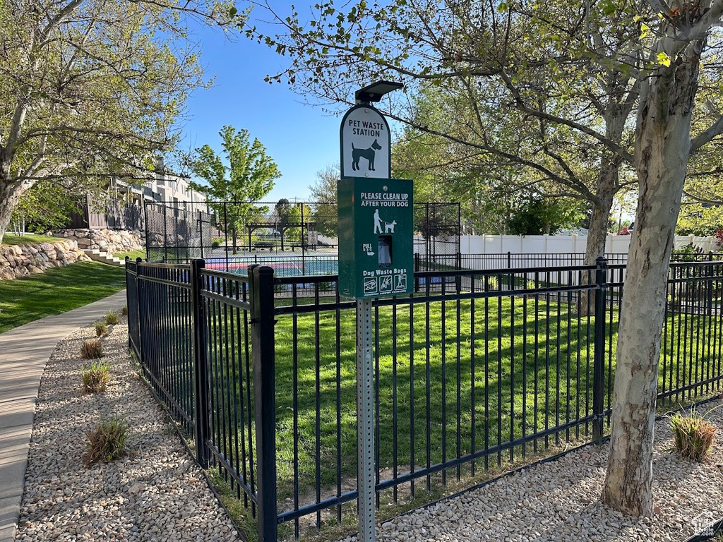 View of gate featuring fence and a lawn