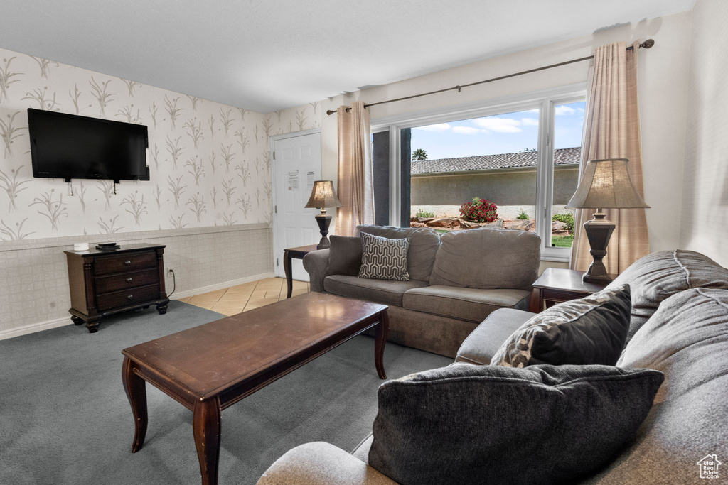 Living area with baseboards, wainscoting, and wallpapered walls