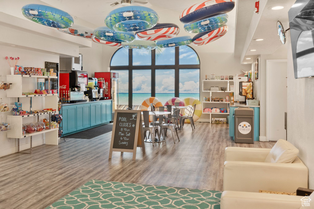 Rec room featuring recessed lighting, wood finished floors, and a water view